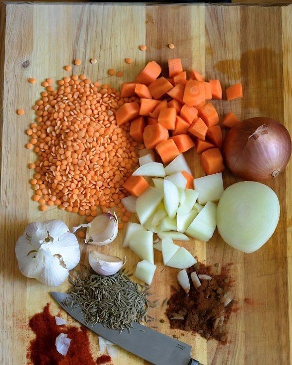 Ingredients for Turkish lentil soup including red lentils carrot onion and potato