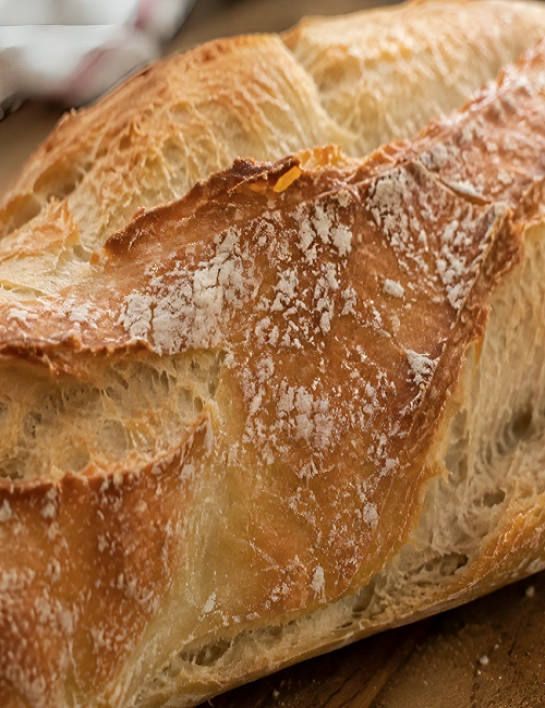 Close-up shot of a freshly baked crusty Spanish barra de pan bread showing texture.