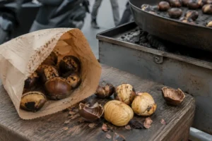 Kestane kebap in a paper bag beside a chestnut roasting cart in Turkey
