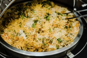 Vegetable biryani rice in a pan with herbs and spices, close-up homemade meatless rice dish