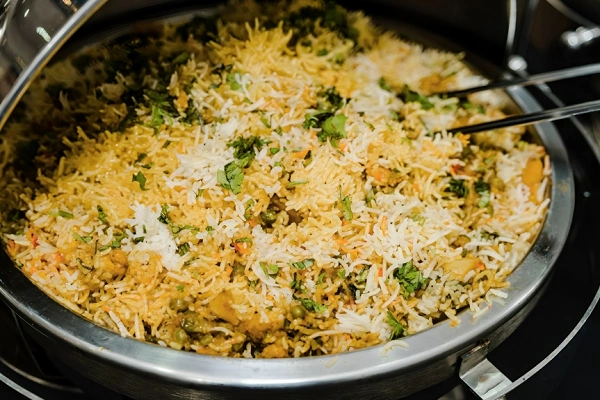 Vegetable biryani rice in a pan with herbs and spices, close-up homemade meatless rice dish
