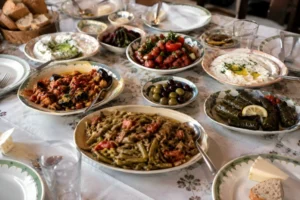 Turkish vegetarian food table with mezze dishes, stuffed grape leaves, lentil dishes, olives, yogurt dips, and fresh salads