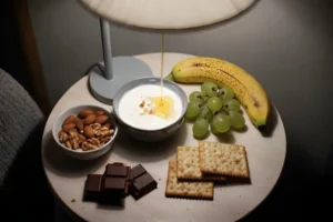 midnight snack ideas no cooking with yogurt nuts fruit crackers and chocolate on cozy bedside table