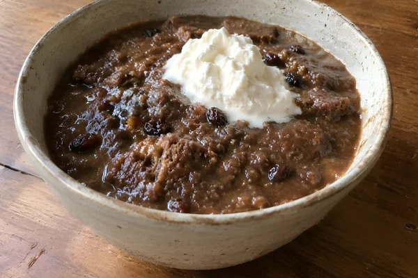 A comforting bowl of cold Leivasupp topped with a dollop of fresh whipped cream